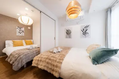 a bedroom with two beds and a large window at Alley Tateishi in Tokyo