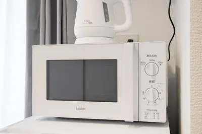 a white microwave with a blender on top of it at Alley Tateishi in Tokyo