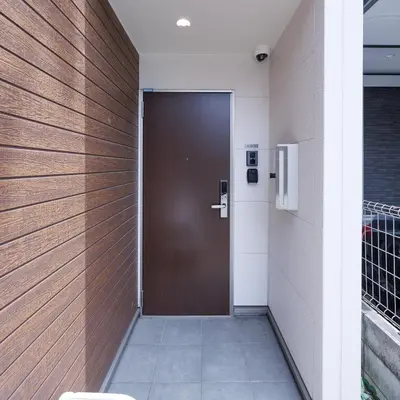 a door in a building with a wooden wall at Negishi 101-TT0029 in Tokyo
