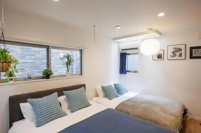 a bedroom with two beds and a window at Negishi 101-TT0029 in Tokyo