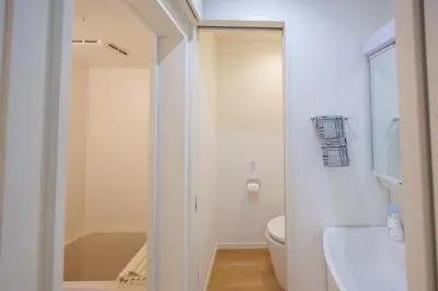 a white bathroom with a toilet and a sink at Negishi 101-TT0029 in Tokyo