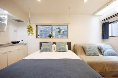a bedroom with two beds and a window at Negishi 101-TT0029 in Tokyo