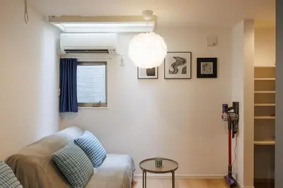 a living room with a couch and a lamp at Negishi 101-TT0029 in Tokyo