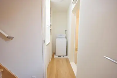 a hallway with a toilet in a white room at Negishi 301-TT0030 in Tokyo