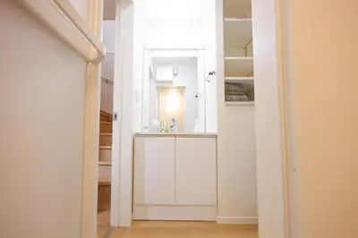 a white bathroom with a sink and a mirror at Negishi 301-TT0030 in Tokyo