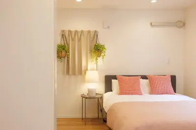 a bedroom with two beds and a table with a lamp at Negishi 301-TT0030 in Tokyo
