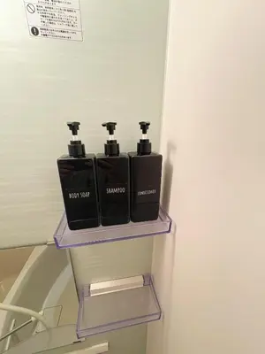 a shelf with four black bottles on a refrigerator at SkyTree View Hikifune Home 1F-105 2min walk to station in Tokyo