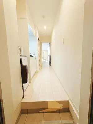 a hallway of a house with white walls and wooden floors at SkyTree View Hikifune Home 1F-105 2min walk to station in Tokyo