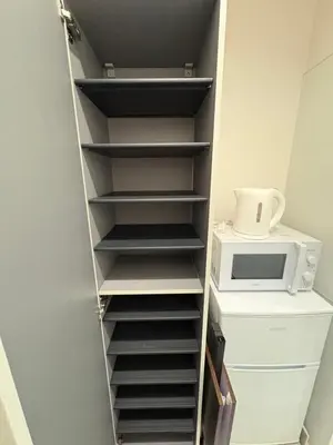 a closet with a shelf with a microwave on it at SkyTree View Hikifune Home 1F-105 2min walk to station in Tokyo