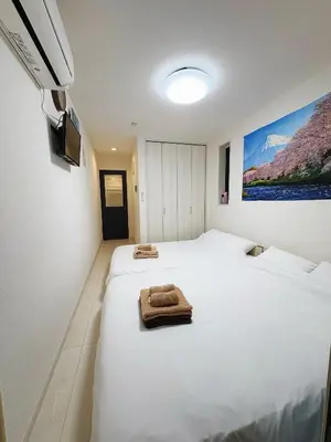 a bedroom with two beds with towels on them at SkyTree View Hikifune Home 1F-105 2min walk to station in Tokyo