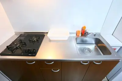 a kitchen with a sink and a stove at 5 Min to Ikebukuro by Tobu Tojo Line I Oyama Private Suites in Tokyo
