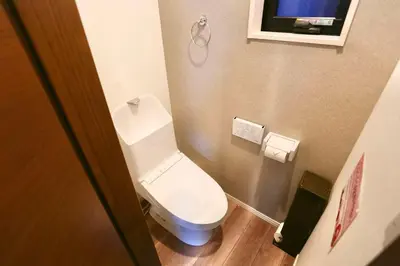 a small bathroom with a toilet and a television at 5 Min to Ikebukuro by Tobu Tojo Line I Oyama Private Suites in Tokyo