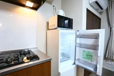 a kitchen with an open refrigerator with a microwave at 5 Min to Ikebukuro by Tobu Tojo Line I Oyama Private Suites in Tokyo