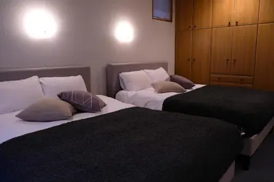 two beds sitting next to each other in a room at Shibuya Goten in Tokyo