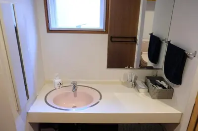 a bathroom counter with a sink and a mirror at Shibuya Goten in Tokyo