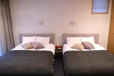 two beds sitting next to each other in a room at Shibuya Goten in Tokyo