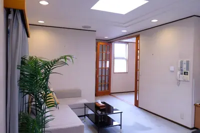 a living room with a couch and a plant at Shibuya Goten in Tokyo