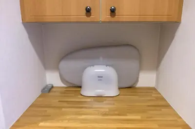 a white appliance sitting in the corner of a room at Shibuya Goten in Tokyo