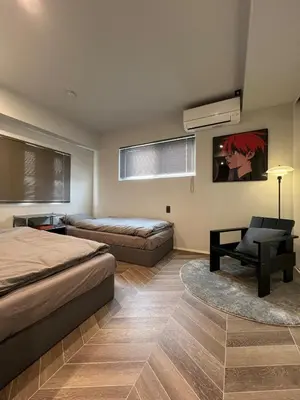 a bedroom with a bed and a couch and a chair at Koenji Designer House, 3 bedrooms,100m2, 5min to Shinjuku in Tokyo