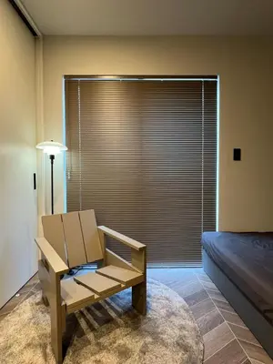 a room with a chair and a window with blinds at Koenji Designer House, 3 bedrooms,100m2, 5min to Shinjuku in Tokyo
