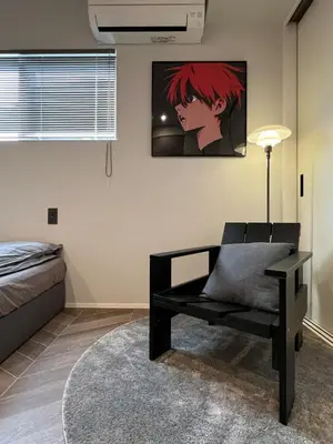 a bedroom with a bed and a chair and a painting at Koenji Designer House, 3 bedrooms,100m2, 5min to Shinjuku in Tokyo