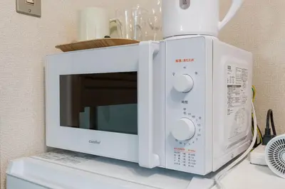 a microwave oven sitting on top of a counter at Setagaya Quiet Residential Apartment201 in Tokyo