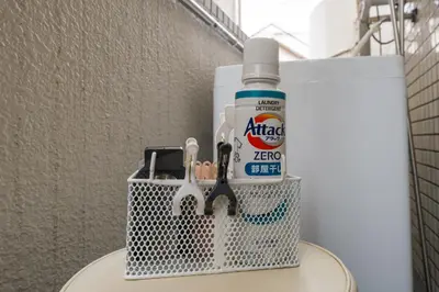 a metal basket with a bottle of toothpaste and scissors at Setagaya Quiet Residential Apartment201 in Tokyo