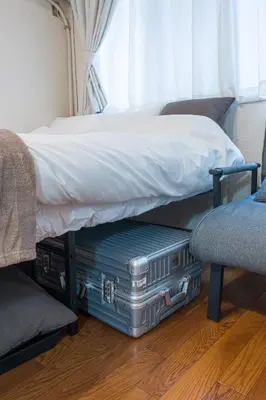 a bed with two suitcases sitting under a bed at Setagaya Quiet Residential Apartment201 in Tokyo