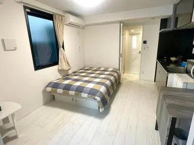 a small room with a bed in a kitchen at Tokyo Goose and Goose Stay Ikebukuro Station 1min walk in Tokyo