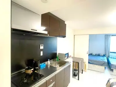 a kitchen with a sink and a bed in a room at Tokyo Goose and Goose Stay Ikebukuro Station 1min walk in Tokyo