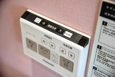 a close up of a digital clock on a wall at iruka hotel 15 minutes to Shinjuku and Shibuya in Tokyo