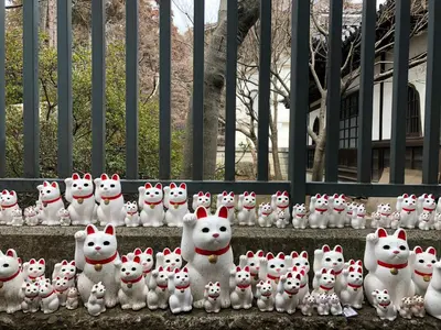a group of white stuffed animals sitting on a fence at iruka hotel 15 minutes to Shinjuku and Shibuya in Tokyo
