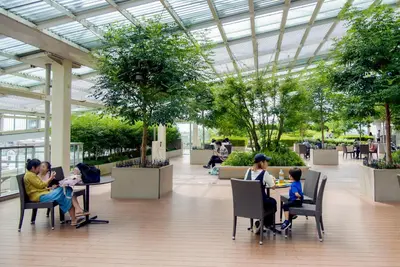 a group of people sitting at tables in a building at iruka hotel 15 minutes to Shinjuku and Shibuya in Tokyo