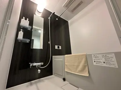 a bathroom with a shower with a mirror and a towel at iruka hotel 15 minutes to Shinjuku and Shibuya in Tokyo