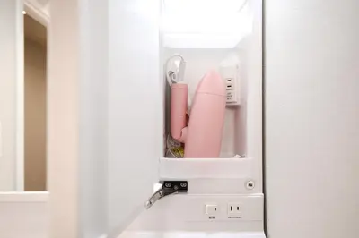 a refrigerator with a pink appliance inside of it at Diamond Residences in Tokyo