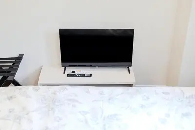 a flat screen tv sitting on top of a bed at Diamond Residences in Tokyo