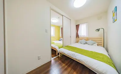 a bedroom with two beds and a large mirror at 30 min to Ueno, Asakusa, Skytree, Akihabara, Ginza in Tokyo