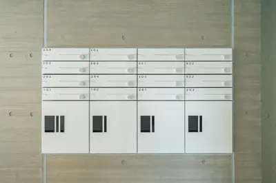 a bunch of white boxes on a wall at unito residence WASEDA West in Tokyo