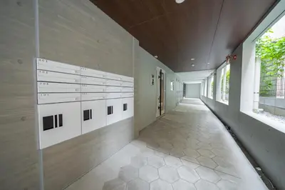 an empty hallway of a building with windows at unito residence WASEDA West in Tokyo