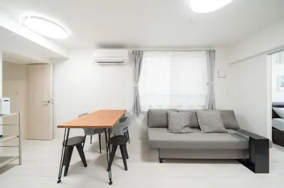 a living room with a couch and a table at unito residence WASEDA West in Tokyo