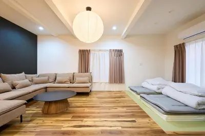 a living room with a couch and a table at YAHIRO Base, 6m walk Yahiro Sta 94m2 2LDK Villa,3 Baths in Tokyo