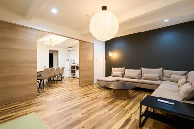 a living room with a couch and a table at YAHIRO Base, 6m walk Yahiro Sta 94m2 2LDK Villa,3 Baths in Tokyo