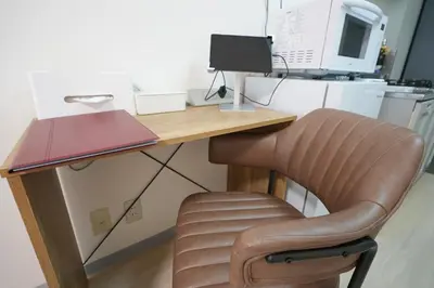 a desk with a chair and a computer monitor at INA HOUSE Koiwa 102 in Tokyo