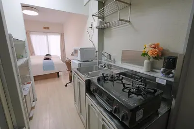 a kitchen with a stove and a sink in it at INA HOUSE Koiwa 102 in Tokyo