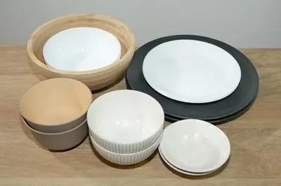 a group of bowls and plates on a table at INA HOUSE Koiwa 102 in Tokyo