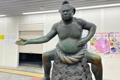 a statue of a man sitting in a building at INA HOUSE Koiwa 102 in Tokyo