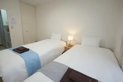 two beds sitting next to each other in a room at INA HOUSE Koiwa 102 in Tokyo