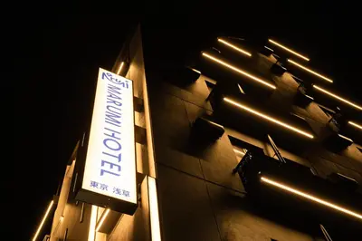 a sign on the side of a building with lights at MARUMI HOTEL Asakusa\u6d45\u8349 in Tokyo