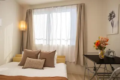 a bedroom with a bed with a window and a desk at MIHOTEL Nakano- Shinjuku Direct in Tokyo
