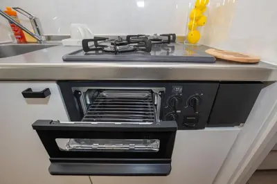 a stove top oven sitting on top of a kitchen counter at MIHOTEL Nakano- Shinjuku Direct in Tokyo